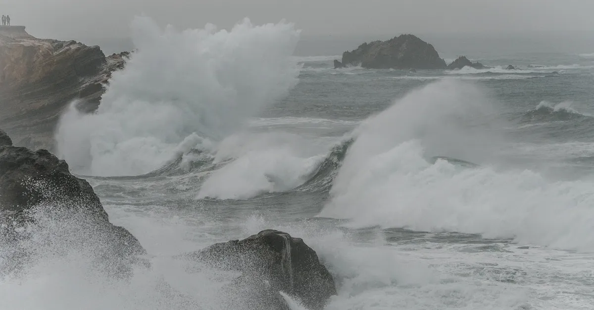 Rough waves crashing onto rocks on a gloomy day at the beach. A rough wave can be like a rough marriage. Learn some important details that may help you in your marriage today!