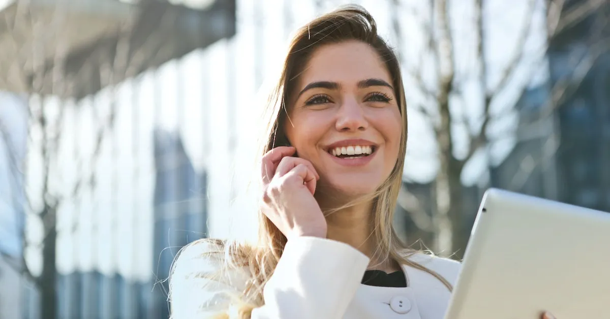 A pretty woman smiling as she's talking on her cell phone. Are you ready to learn how to find a wonderful career? Learn more in this article.