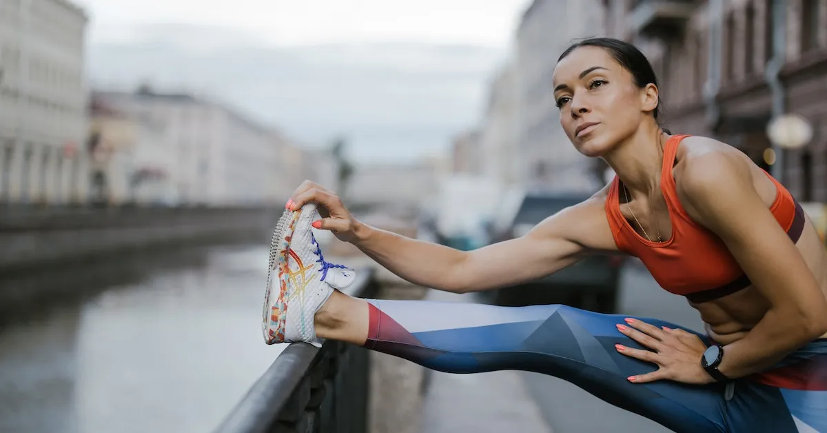 A woman wearing exercise clothes and stretching outside. Do you think exercise is really worth your time? Find out more in this article.