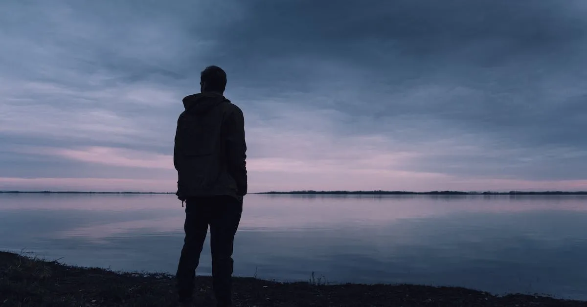 A man standing close to a lake early in the morning. He is contemplating if pornography is bad. Find out if it really is in this article.