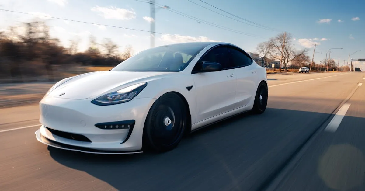 A white Tesla cruising on a sunny day. Learn about maintenance on electric vehicles.