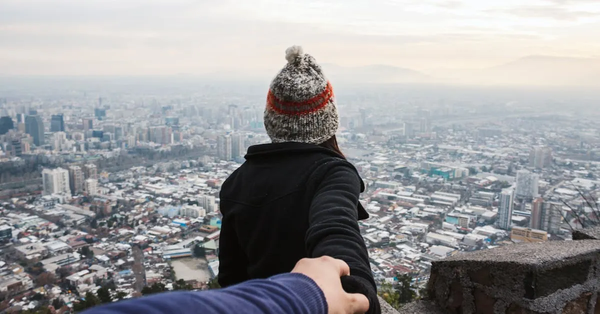 A woman leading a man to the top of a city on a high cliff. He trusts her completely. Similarly, we can trust God in EVERY area of our lives.