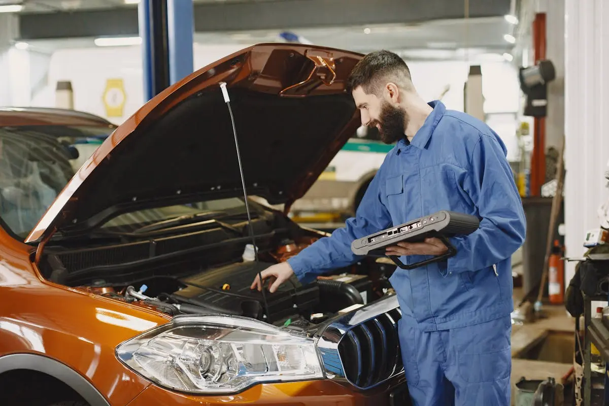 An automotive technician inspecting a vehicle using a hand held computer to diagnose the system. Are you searching for a Master Certified Technician? If so, learn what it means to be certified and how that qualification may help you as a customer. Take a look at our latest article.