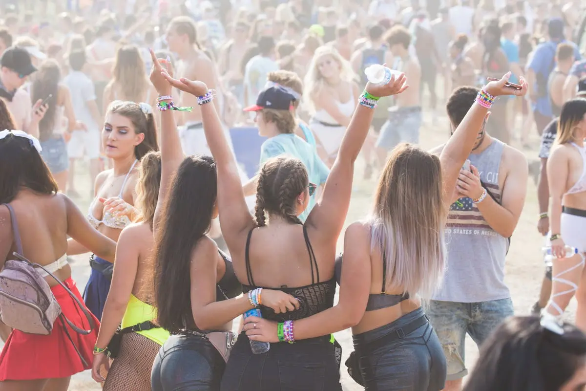 A group of young adults having fun at a music festival. The image conveys the liberal lifestyle of this generation, especially Christians. Learn what a liberal Christian is in our latest article.